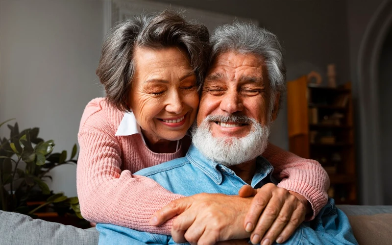 אישה מחבקת את בעלה ומחייכים